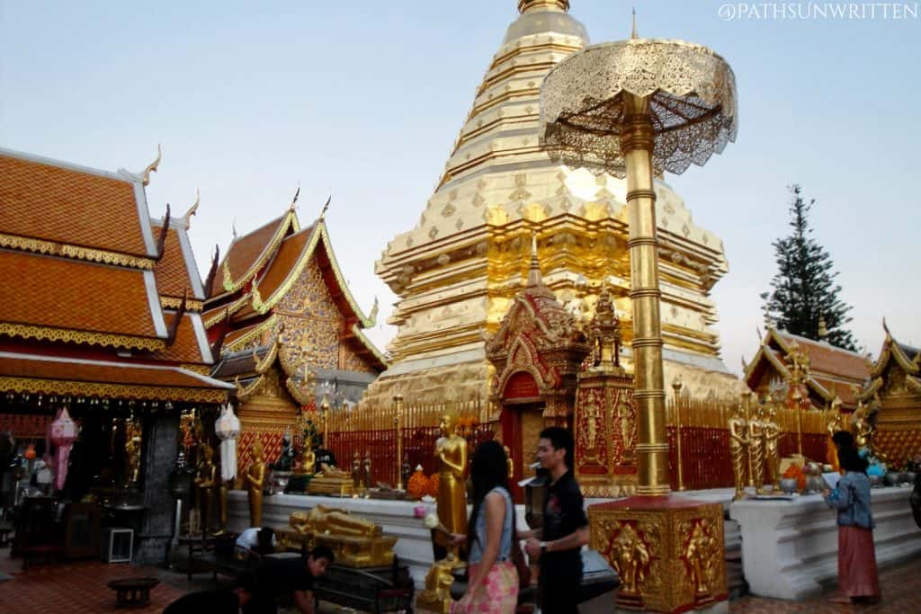 The central chedi of Wat Phrathat Doi Suthep surrounded by numerous Buddha idols.